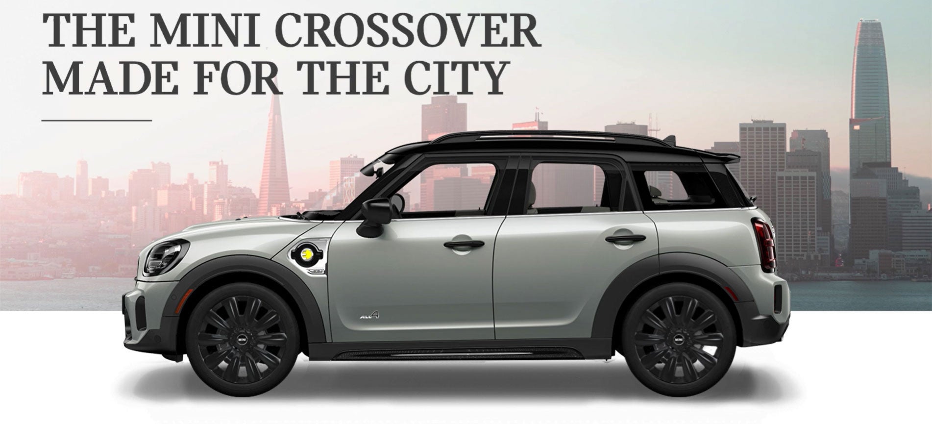 The MINI Cooper SE Countryman PHEV parked in front of a city scape. MINI of Rochester in Rochester NY