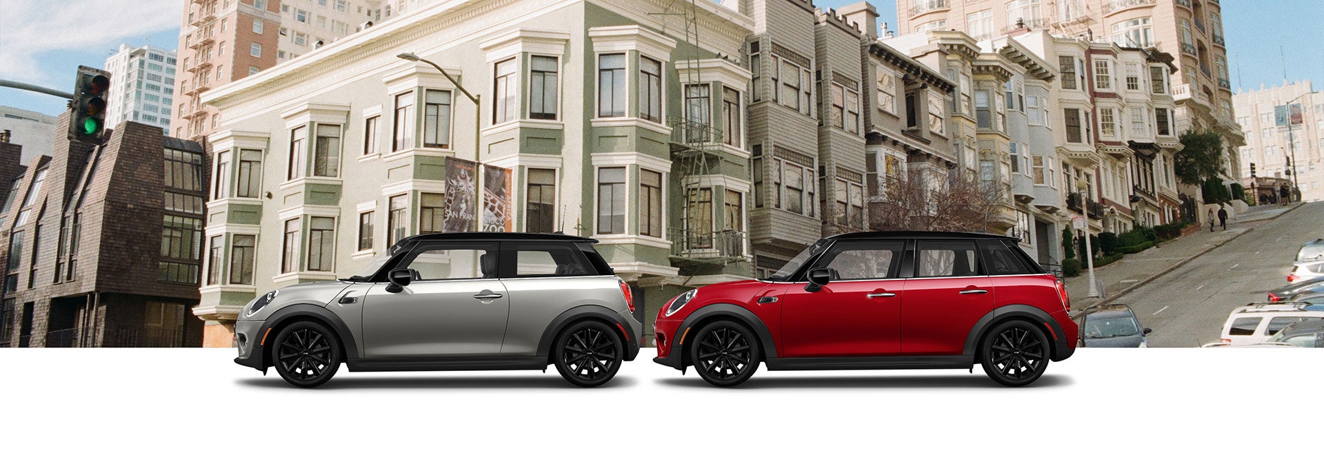 Grey Oxford Edition MINI Cooper 2 Door Hardtop and Red Oxford Edition MINI Cooper 4 Door Hardtop in front of cityscape | MINI of Rochester in Rochester NY