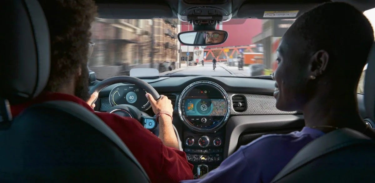 View of a couple enjoying their ride in an electric MINI.