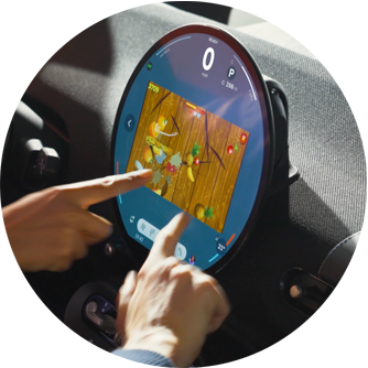 Two hands playing the video game Fruit Ninja while parked on the MINI OLED Display.